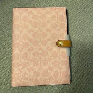 coach powder pink notebook in signature canvas